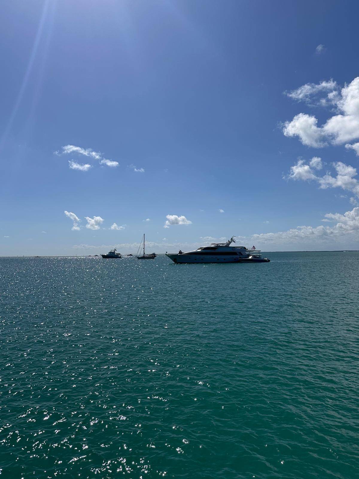Motor yacht at anchor under a blue sky